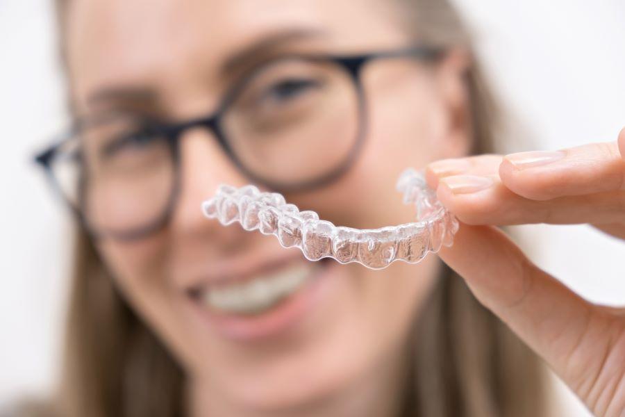 A dentist holding invisalign braces at Train Station Dental,NJ
