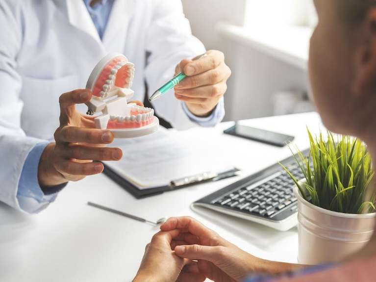 A dentist and patient during a dental implants consultation in Audubon, NJ